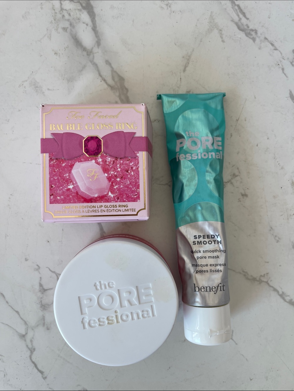 Benefit skincare trio with teal tube and pink gloss box